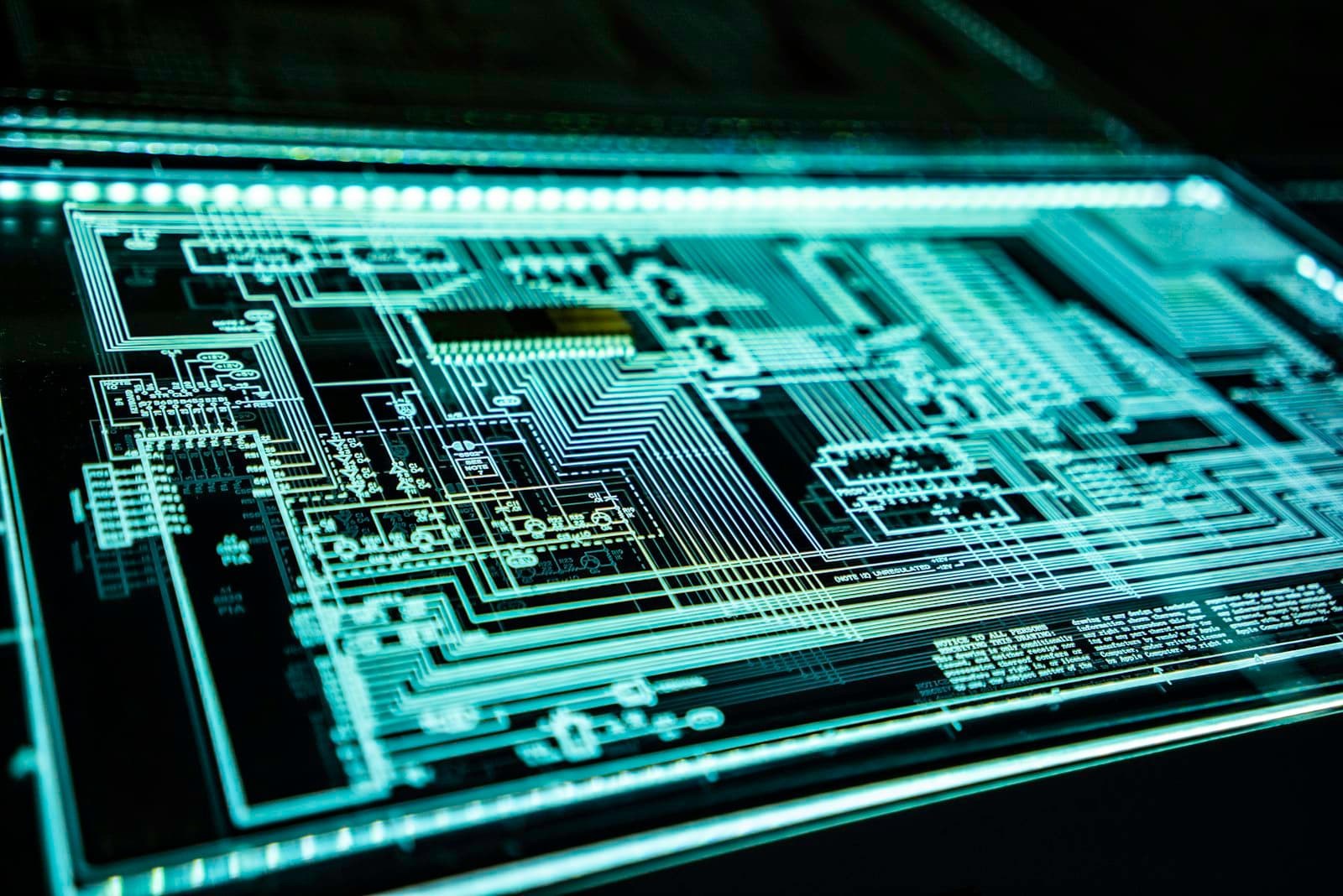 An abstract macro shot of an illuminated circuit board, representing image recognition technology.